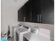 Functional laundry area features cabinets, a counter, and modern appliances at 5954 Anise Dr, Sarasota, FL 34238