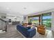 Open concept living room flows to the kitchen and overlooks the patio and lake at 5954 Anise Dr, Sarasota, FL 34238