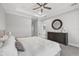Elegant main bedroom with a round mirror, contemporary dresser, and a peek into the ensuite bathroom at 5954 Anise Dr, Sarasota, FL 34238