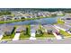 Aerial view of community featuring lush landscaping, solar panels, and a serene water view at 6105 114Th E Dr, Parrish, FL 34219