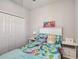 Comfortable bedroom features mermaid themed comforter, side tables with drawers, and ample closet space at 6105 114Th E Dr, Parrish, FL 34219