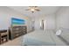 Spacious bedroom with a ceiling fan and a large dresser with a TV at 6105 114Th E Dr, Parrish, FL 34219