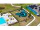 Aerial view of community playground, pool, and pond in The Retreat at Willow Bend at 6105 114Th E Dr, Parrish, FL 34219