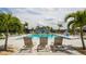 Community pool with plenty of lounge chairs and palm trees at The Retreat at Willow Bend at 6105 114Th E Dr, Parrish, FL 34219