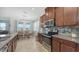 The updated kitchen features stainless steel appliances and a decorative backsplash, connecting to the dining area at 6105 114Th E Dr, Parrish, FL 34219