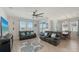 Spacious living room featuring comfortable seating, tile floors, and a view of the lake at 6105 114Th E Dr, Parrish, FL 34219