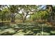 Tennis court surrounded by lush trees and nature. The court is regulation with great visibility at 6105 114Th E Dr, Parrish, FL 34219
