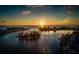 Stunning aerial view of sunset over bay with boat on water at 700 Golden Beach Blvd # 222, Venice, FL 34285