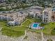 This aerial view highlights community with a pool, parking, tennis courts, landscaping and beach access at 700 Golden Beach Blvd # 222, Venice, FL 34285