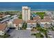 The aerial showcases a beachfront complex with a pool, a parking lot, and manicured landscaping at 700 Golden Beach Blvd # 222, Venice, FL 34285