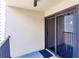 Secluded balcony with a sliding glass door, neutral walls, and a railing offering privacy and outdoor space at 700 Golden Beach Blvd # 222, Venice, FL 34285