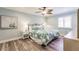 Relaxing bedroom with ceiling fan, leafy bedding, and wood-look flooring at 700 Golden Beach Blvd # 222, Venice, FL 34285