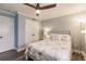 Cozy bedroom with a ceiling fan, closet, and a comfortable bed with a decorative comforter and stylish pillows at 700 Golden Beach Blvd # 222, Venice, FL 34285
