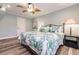 Bedroom featuring ceiling fan, wood-look floors, and leafy bedding at 700 Golden Beach Blvd # 222, Venice, FL 34285