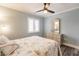 Inviting bedroom featuring a window, ceiling fan, and a dresser with a mirror above the comfortable, patterned bed at 700 Golden Beach Blvd # 222, Venice, FL 34285
