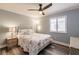 Serene bedroom with ceiling fan, wood-look floors, and shell-themed bedding at 700 Golden Beach Blvd # 222, Venice, FL 34285