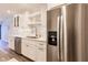 Updated kitchen with stainless steel appliances, white cabinets and open shelving at 700 Golden Beach Blvd # 222, Venice, FL 34285