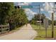 Scenic view of The Legacy Trail, with cyclist enjoying the tree-lined path with safety rules at 700 Golden Beach Blvd # 222, Venice, FL 34285