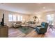 Inviting living room with wood floors, plush seating, and bright, shuttered windows at 700 Golden Beach Blvd # 222, Venice, FL 34285