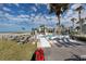 Enjoy the oceanfront pool with lounge chairs, tables, and palm trees for a relaxing resort lifestyle at 700 Golden Beach Blvd # 222, Venice, FL 34285