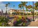 Charming street view featuring tropical plants and flowers with various building architecture at 700 Golden Beach Blvd # 222, Venice, FL 34285