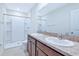 Bathroom with double sinks, modern fixtures, and a spacious walk-in shower at 8657 Milestone Dr, Sarasota, FL 34238