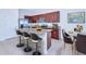 Kitchen features a large island, stainless steel appliances, granite countertops, and modern lighting fixtures at 8657 Milestone Dr, Sarasota, FL 34238