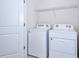 Well-equipped laundry room with modern washer and dryer units at 8657 Milestone Dr, Sarasota, FL 34238