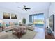Comfortable living room featuring a large window, neutral-toned furniture, and stylish decor at 8657 Milestone Dr, Sarasota, FL 34238