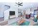 Open-concept living area with a modern decor, tile floors, and an adjacent kitchen and dining space at 8657 Milestone Dr, Sarasota, FL 34238