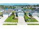 Overhead view of a charming two-story home with a well-manicured lawn and a serene lake backdrop at 10614 Morning Marsh Ln, Parrish, FL 34219