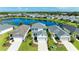Beautiful aerial view of a two-story home in a lakeside community with manicured lawns and lush landscaping at 10614 Morning Marsh Ln, Parrish, FL 34219