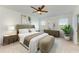 Bedroom with a modern aesthetic, natural light, plush bedding, and stylish decor at 10614 Morning Marsh Ln, Parrish, FL 34219