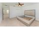 Bedroom featuring carpet, a ceiling fan, natural light, closet, and a gray upholstered headboard at 10614 Morning Marsh Ln, Parrish, FL 34219
