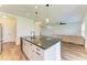 Kitchen featuring white cabinets, an island with pendant lighting, and stainless steel appliances at 10614 Morning Marsh Ln, Parrish, FL 34219