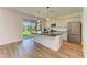 Modern kitchen island with black countertops and stainless steel appliances, plus a view of the outdoors at 10614 Morning Marsh Ln, Parrish, FL 34219