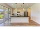 Kitchen with white cabinetry, a large center island, stainless appliances and view of the backyard at 10614 Morning Marsh Ln, Parrish, FL 34219