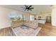 Spacious living room featuring wood floors, ceiling fan, and view of the kitchen at 10614 Morning Marsh Ln, Parrish, FL 34219