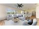 Comfortable living room with modern decor, lots of natural light, and open concept to the kitchen at 10614 Morning Marsh Ln, Parrish, FL 34219