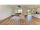 Spacious living room featuring wood floors, ceiling fan, and view of the outdoors at 10614 Morning Marsh Ln, Parrish, FL 34219