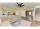 Open-concept area featuring wood floors, a modern kitchen, and staircase to the second floor at 10614 Morning Marsh Ln, Parrish, FL 34219