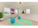 Carpeted loft area with yoga mats, exercise balls, natural light, and white walls at 10614 Morning Marsh Ln, Parrish, FL 34219