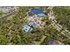 Aerial view of community amenities, including tennis courts, clubhouse, and inviting outdoor pool at 12352 Auburndale Ct, Venice, FL 34293