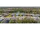 Stunning aerial view of homes surrounding a lake, showcasing lush landscaping and serene water views at 12352 Auburndale Ct, Venice, FL 34293