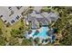 Bird's-eye perspective of clubhouse pool surrounded by palm trees, offering resort-style living at 12352 Auburndale Ct, Venice, FL 34293