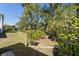Lush backyard featuring mature trees and landscaping at 12352 Auburndale Ct, Venice, FL 34293