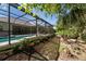 Landscaped backyard with walkway and screened in pool at 12352 Auburndale Ct, Venice, FL 34293