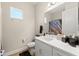 Well-lit bathroom with a single vanity, toilet, and shower with decorative shower curtain at 12352 Auburndale Ct, Venice, FL 34293