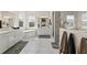 Bright and spacious bathroom with a soaking tub, double vanity, and a walk-in shower with marble-style tile at 12352 Auburndale Ct, Venice, FL 34293