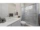 Modern bathroom features a vanity with a chrome faucet, a glass-enclosed shower with marble tile, and updated fixtures at 12352 Auburndale Ct, Venice, FL 34293